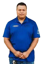 Man in a blue polo shirt standing and facing forward with hands clasped in front.
