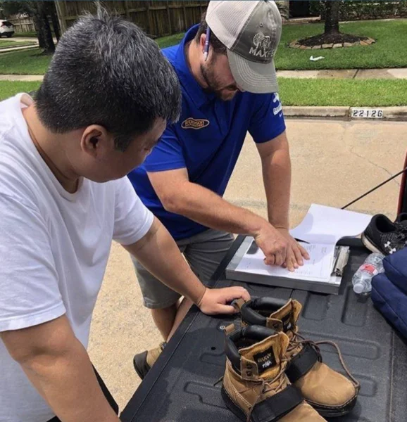 An Anderson Restoration employee helping with insurance claim for a homeowner struggling with fire and smoke damage