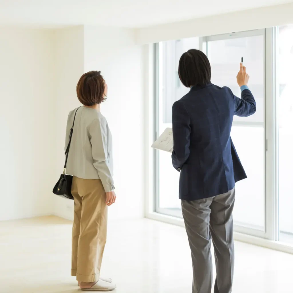 This is a sample image for the blog "How to Handle Water Damage in your Apartment" showing tenant and landlord discussing the property