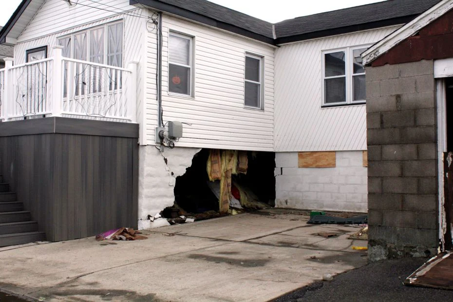 Image of a house with visible water leaks on the roof and walls, highlighting potential issues like mold, ceiling stains, and water damage.