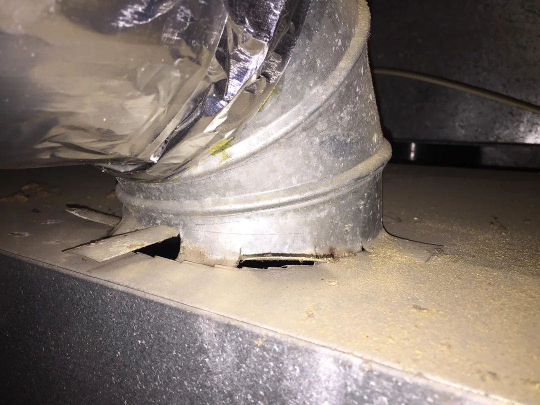 Damaged ductwork connection showing gaps and poor sealing, which can lead to ventilation issues and moisture buildup.