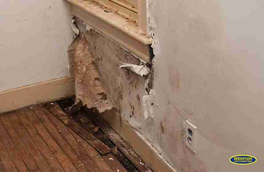 Severe wall and floor damage caused by HVAC unit leakage, highlighting the urgent need for water damage restoration in The Woodlands, TX.