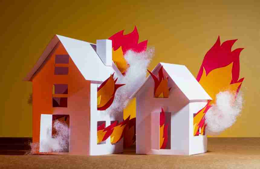 Illustration of two paper houses on fire, symbolizing residential fire damage in Houston, TX.
