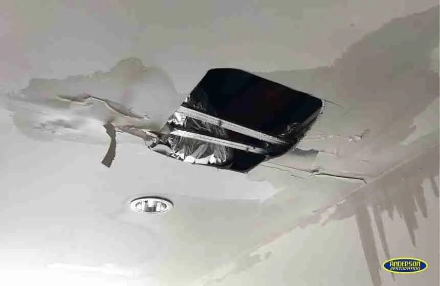 Ceiling water damage with exposed ductwork in residential home
