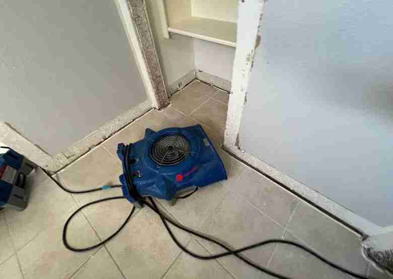 Water damage experts near me placed a drying fan on the floor to remove excess moisture. The equipment is set up inside a home to prevent further water damage and mold growth.