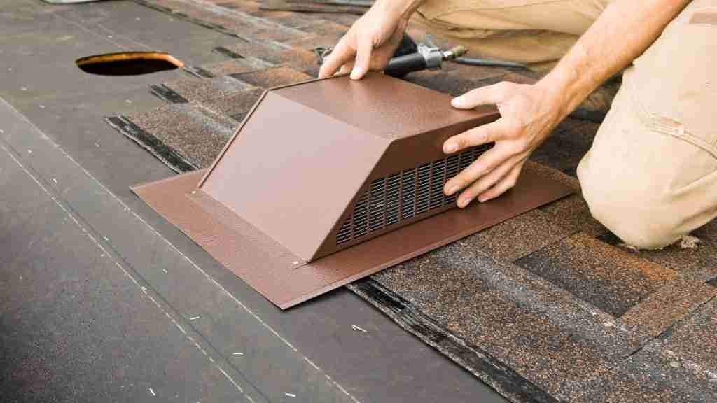 Roofer replacing a pipe boot gasket on a residential roof