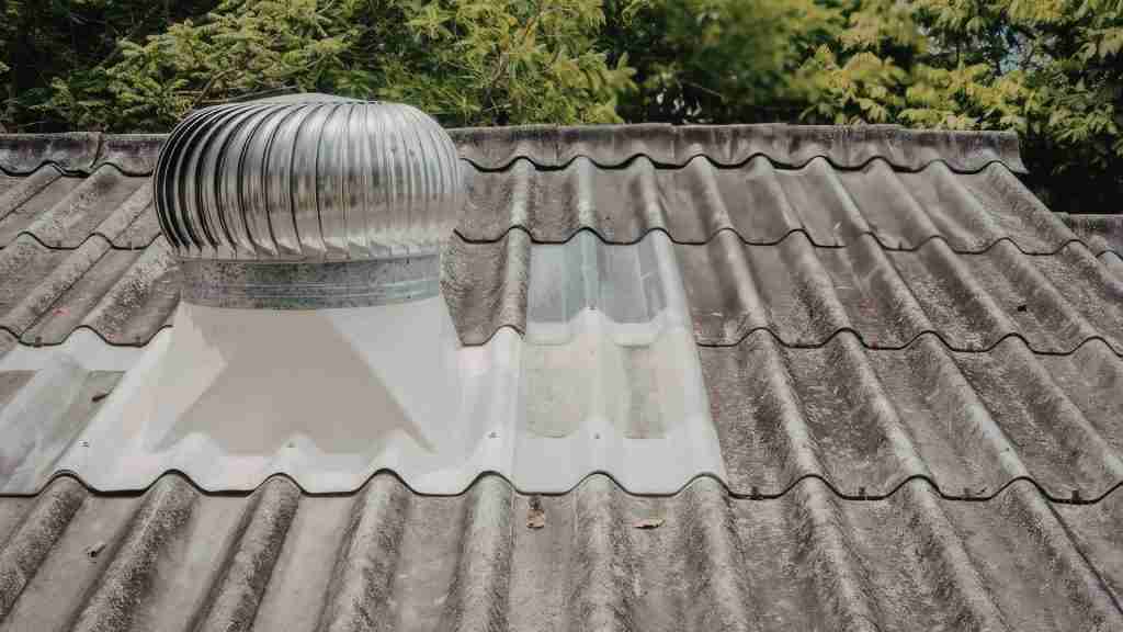 Diagram-style photo showing installed ridge vent along a roof peak with arrows indicating airflow direction, residential Houston home