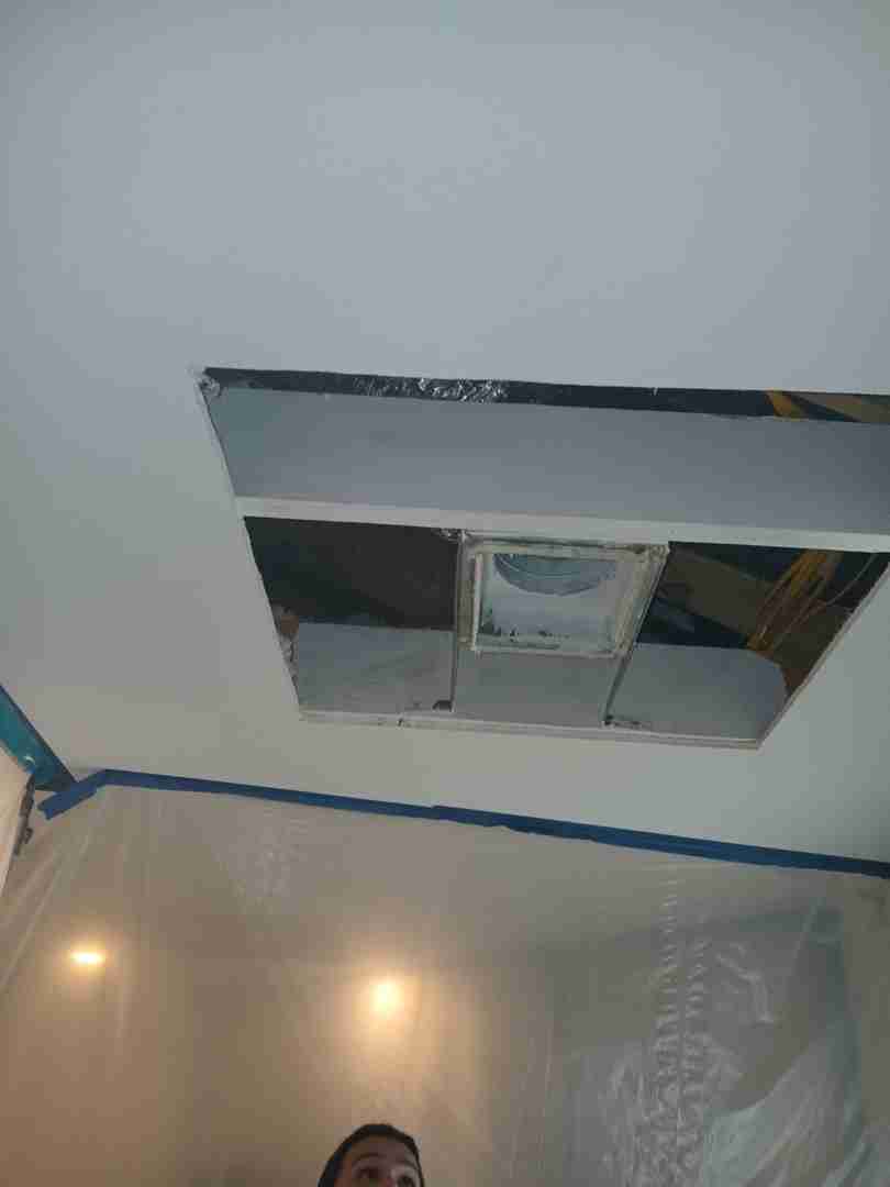 Opened ceiling cavity revealing HVAC ductwork and contaminated framing in Angleton residence