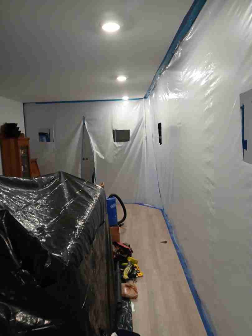 Full plastic containment barrier set up in living area to isolate mold remediation work zone