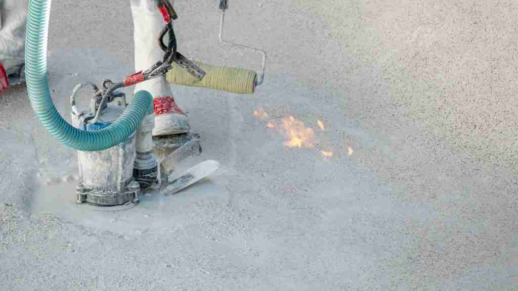 Close-up of a roofing technician using a hot-air welder on the seam of a white TPO membrane, with a probe and test patch showing quality-control checks in the foreground
