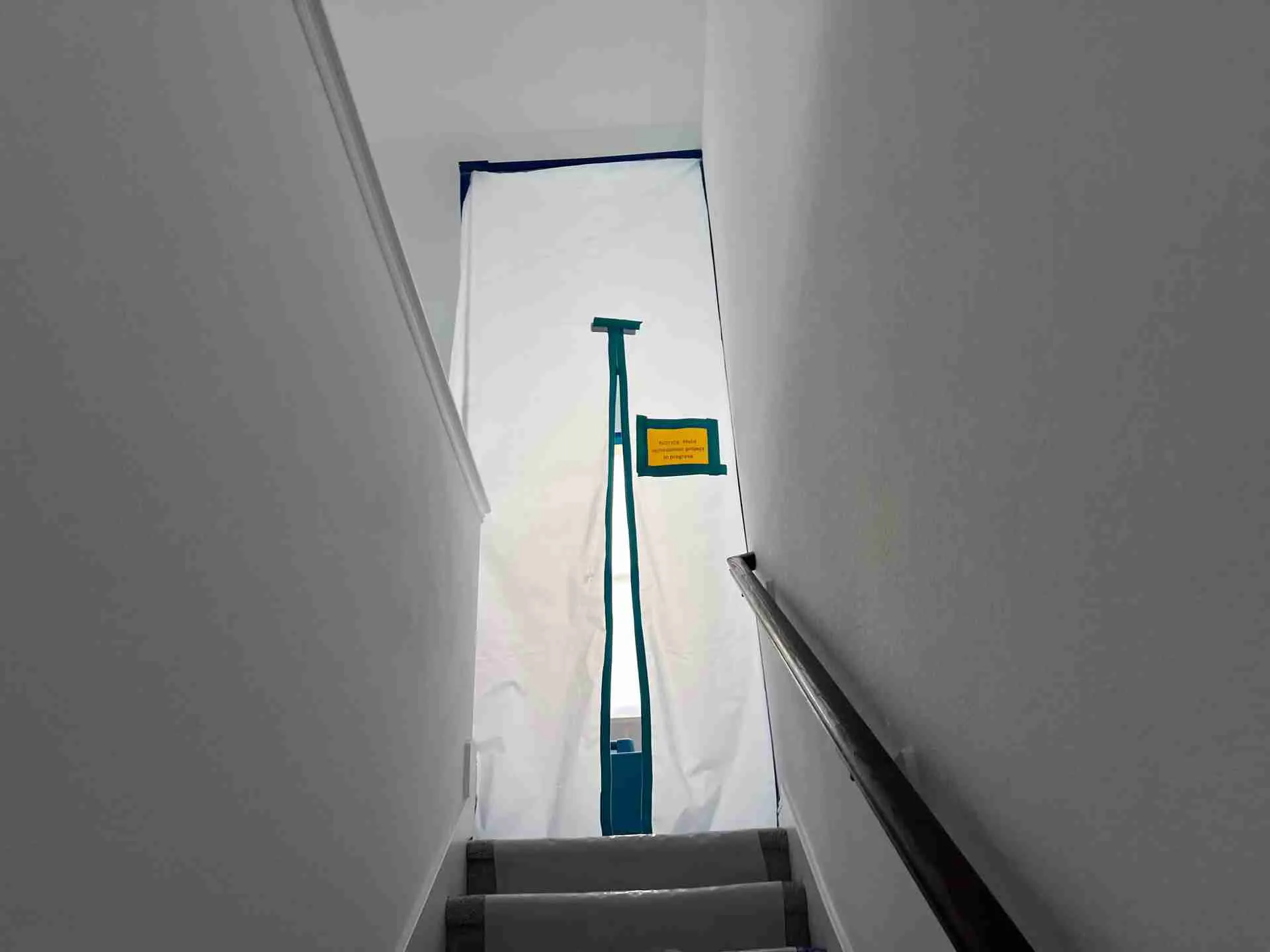 Negative pressure containment barrier with a posted mold remediation notice at a Houston job site