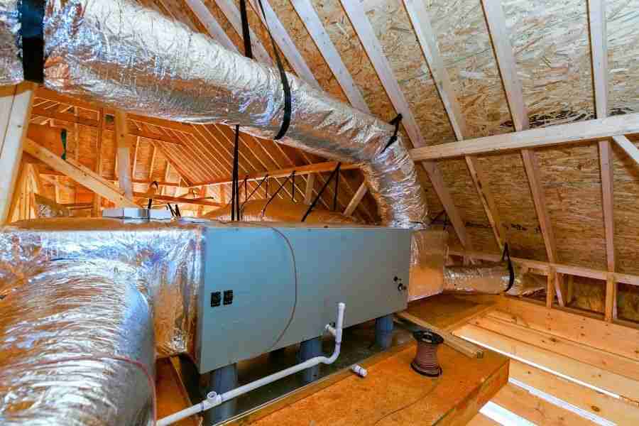 Insulated HVAC ductwork and air handler unit installed in the attic of a residential Houston home
