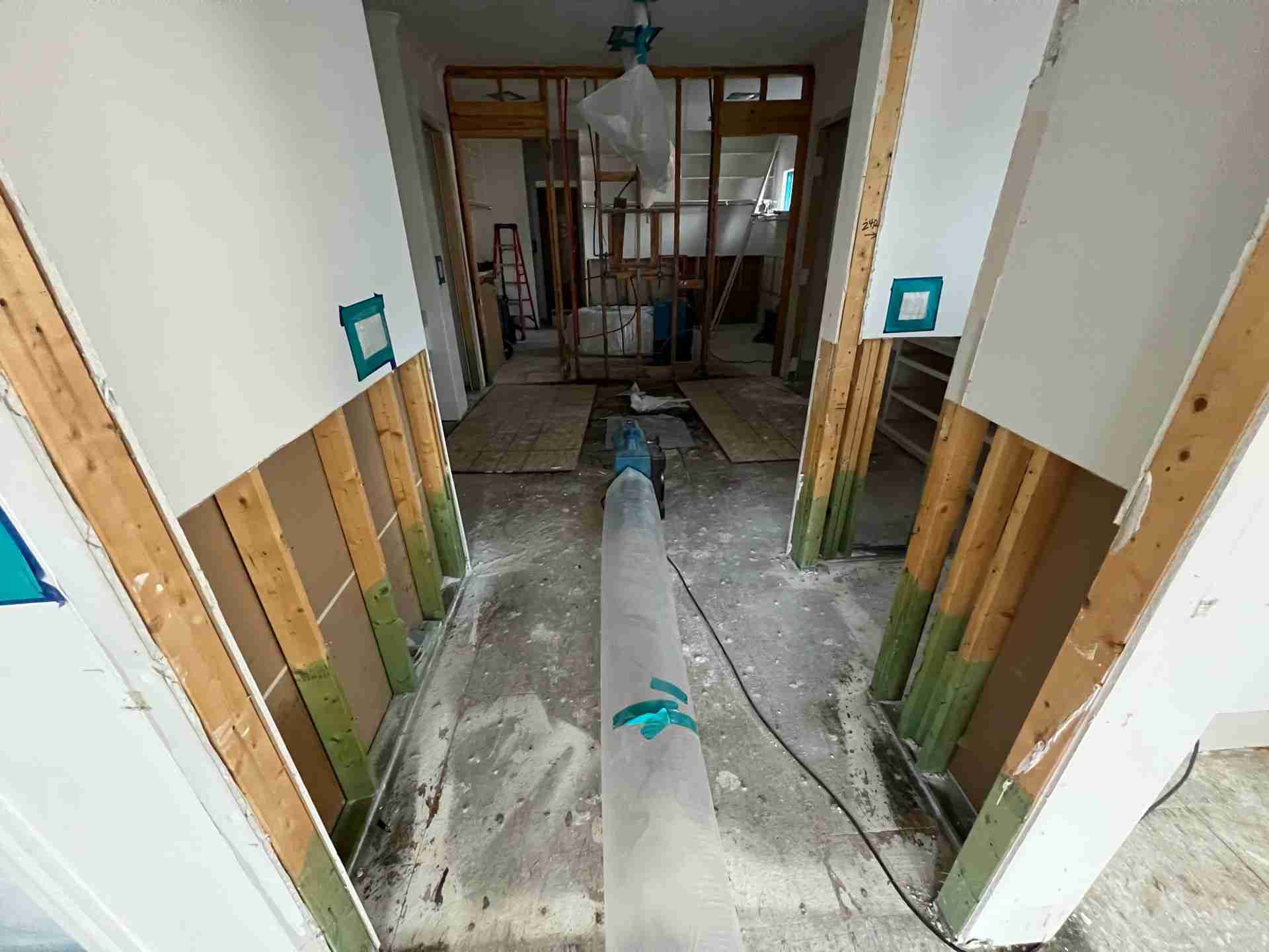 Hallway flood cut with air ducting set up for controlled structural drying