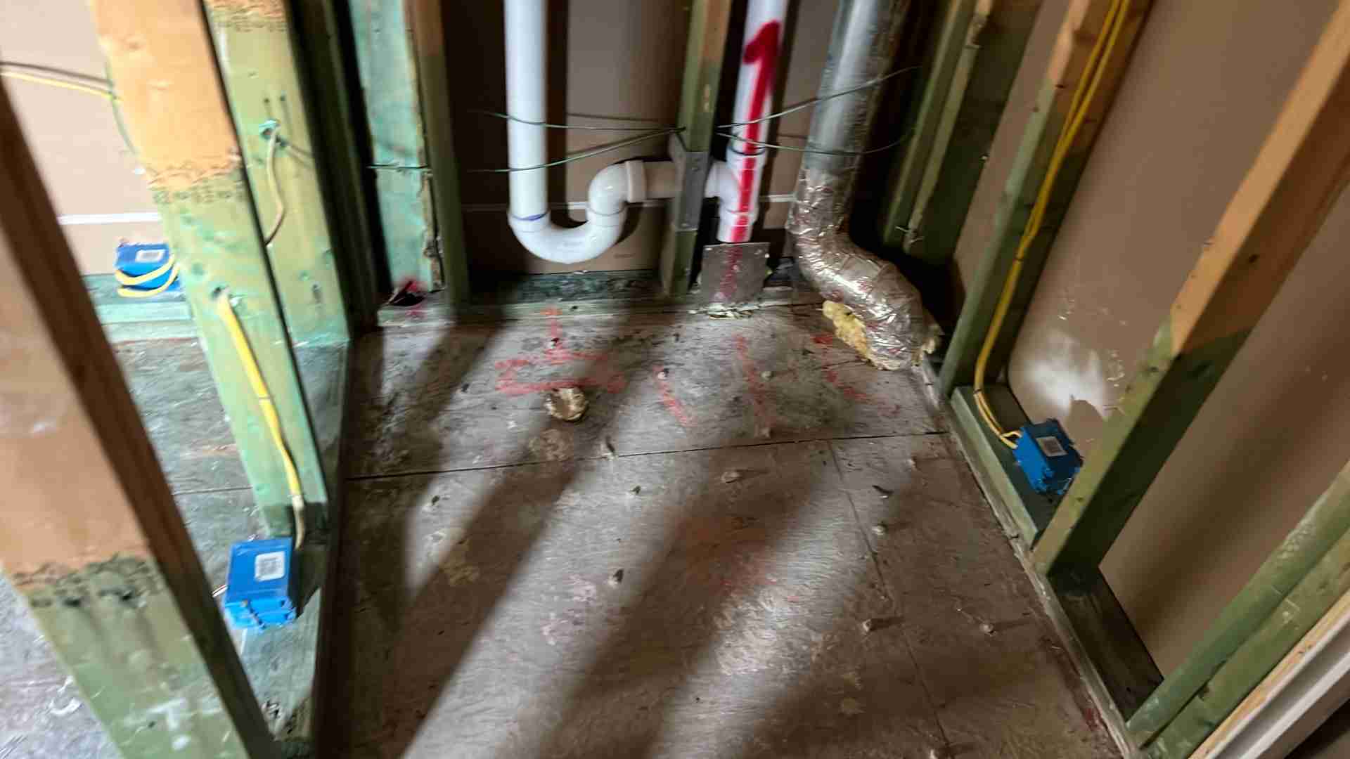 Dried framing and rough plumbing exposed after mold remediation in a Bellaire TX home