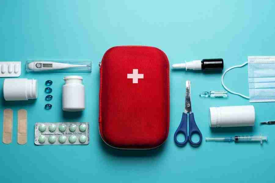 Hurricane emergency kit with bottled water, flashlight, batteries, and first aid supplies laid out on a table