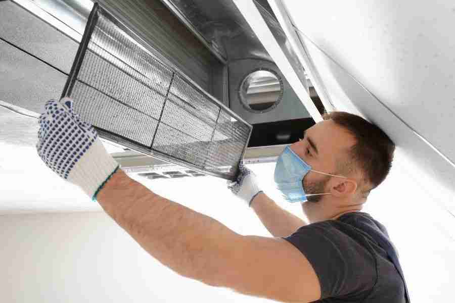 IICRC-certified technician cleaning mold from an HVAC system in a Cypress, TX home