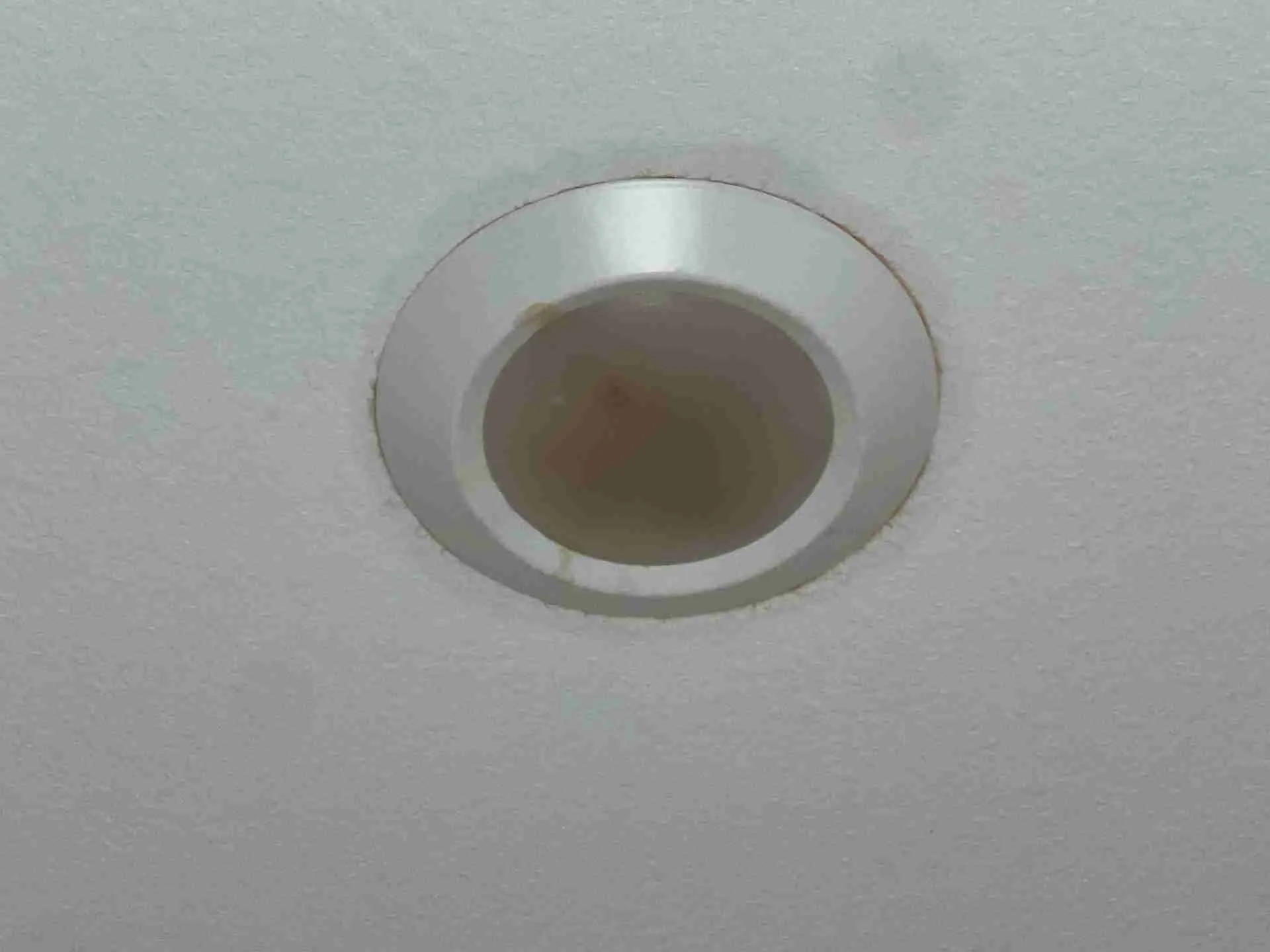 Water collected inside a recessed ceiling light housing in a Fulshear TX residential water damage loss