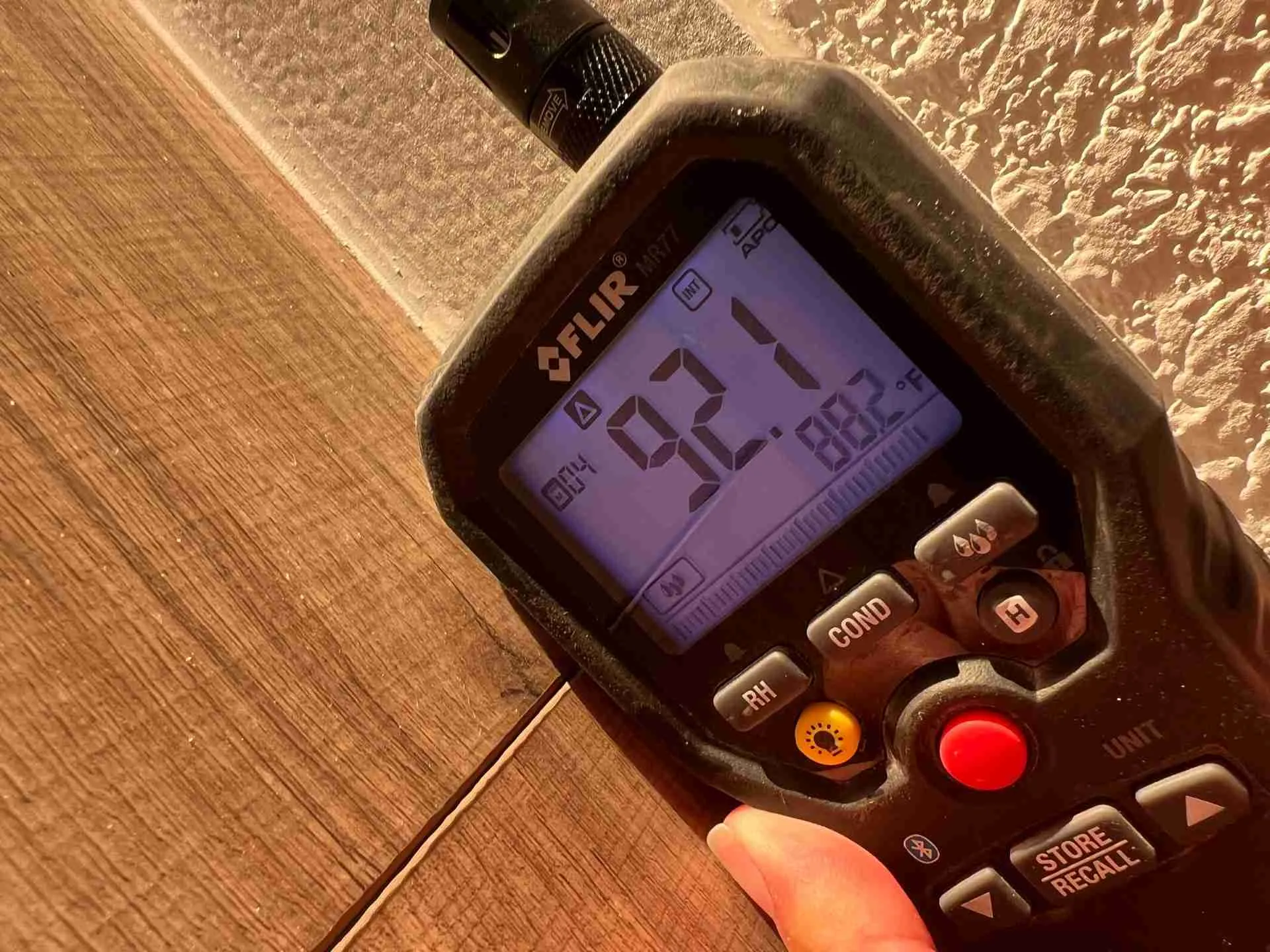 Elevated moisture meter reading at a baseboard during water damage restoration in Fulshear TX
