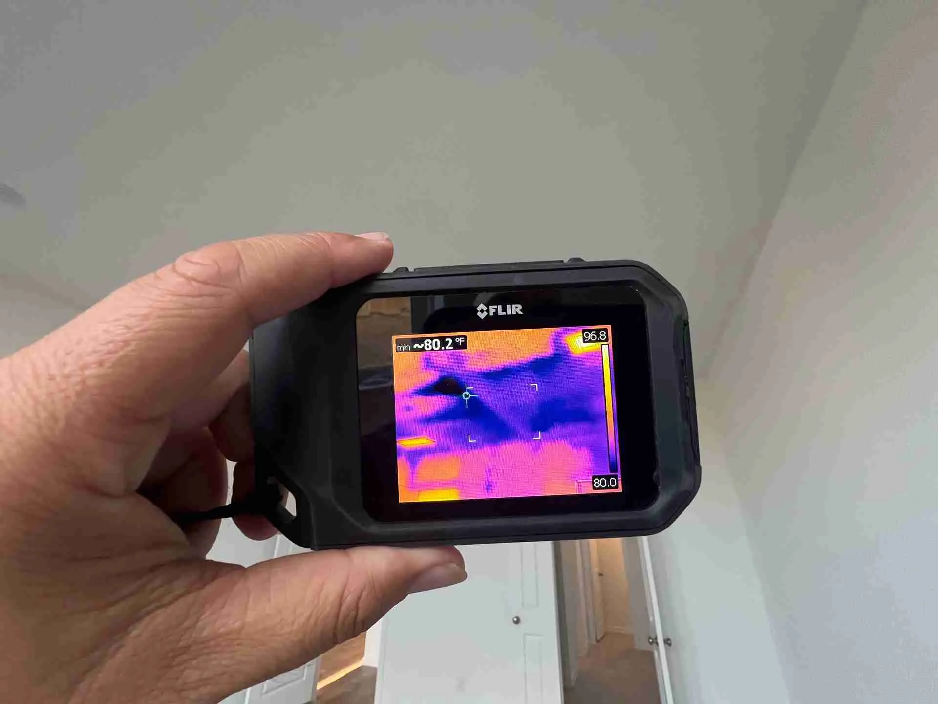 Thermal imaging camera revealing hidden moisture behind a wall during water damage inspection in Fulshear TX